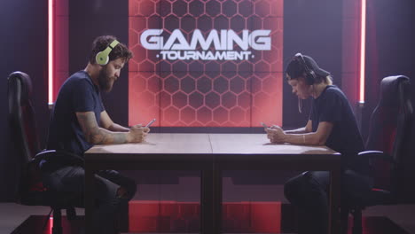 two gamers competing in a mobile gaming tournament