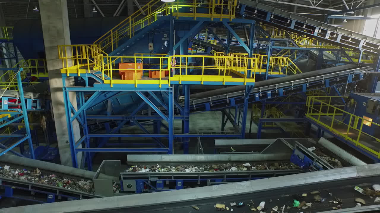 Inside View Of Conveyor Belts Moring And Sorting Public Waste Trash At Refuse Warehouse