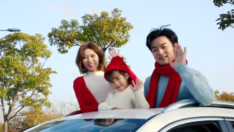 cheerful asian family with father, mother and daughter excited for holiday adventure in compact car are smiling and driving for travel on vacation