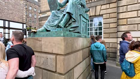 people gather around hume statue during festival