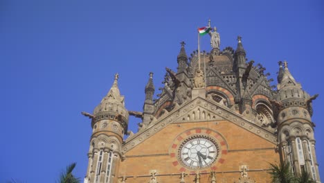 unesco site chhatrapati shivaji maharaj terminus railway station or victoria terminus building architectural details, indian national flag waving at csmt station