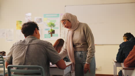 teacher helping students in classroom