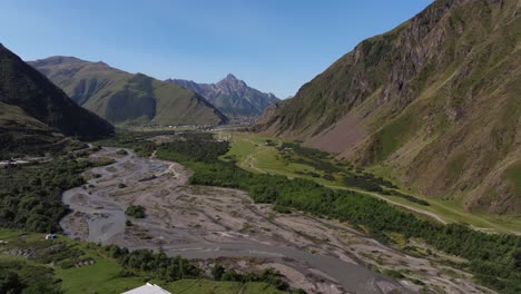 aerial pullback reveals terek river in georgian mountain valley