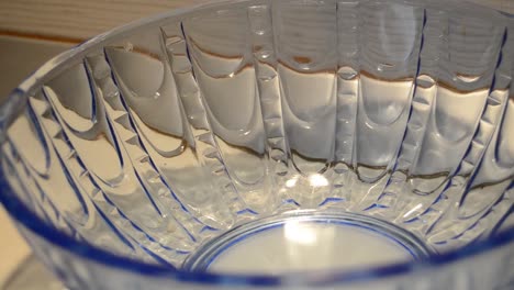 woman hand taking last cookie buiscut from blue glass bowl shugar addiction concept