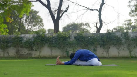 indian man doing knee to head yoga pose in side angle