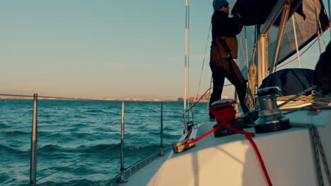 men, rope and sail for boat by ocean