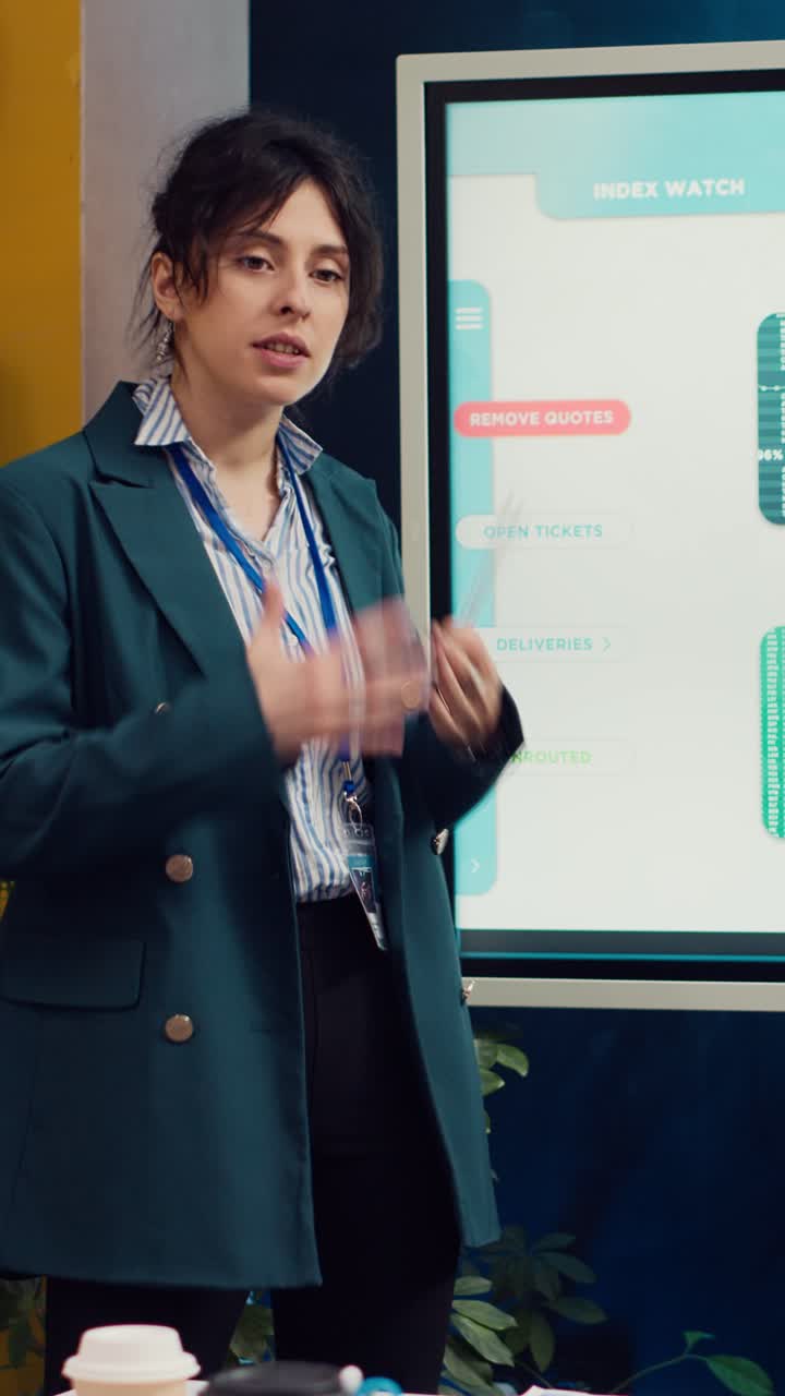 Woman Presenting Business Data on Vertical Screen in Office Meeting