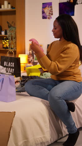 excited woman unboxing gifts on black friday