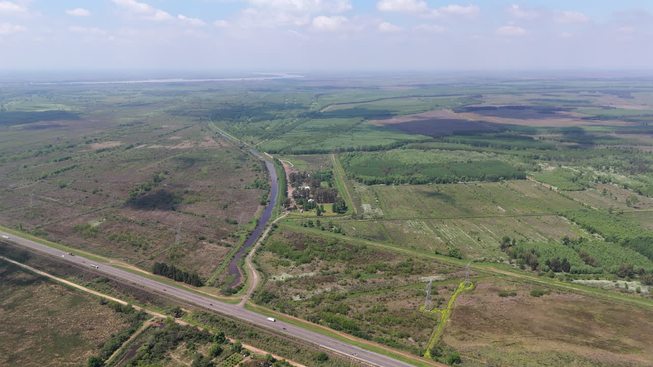 Aerial view of Paraná River Delta wetlands and highway crossing fertile plains
