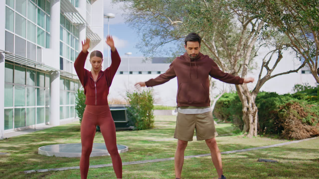 Active athletes training park in morning. Focused man woman preparing workout