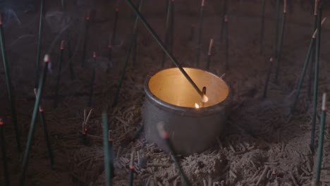 Lighting-incense-inside-of-traditional-japanese-temple,-Slow-Motion