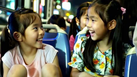 happy children on a night bus ride