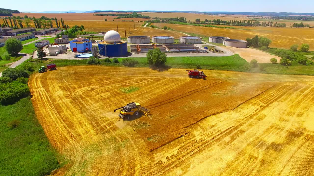 Aerial view of combine harvester. Harvest of wheat field. Industrial background on agricultural theme. Biofuel and food production from above. Agriculture and environment in European Union.