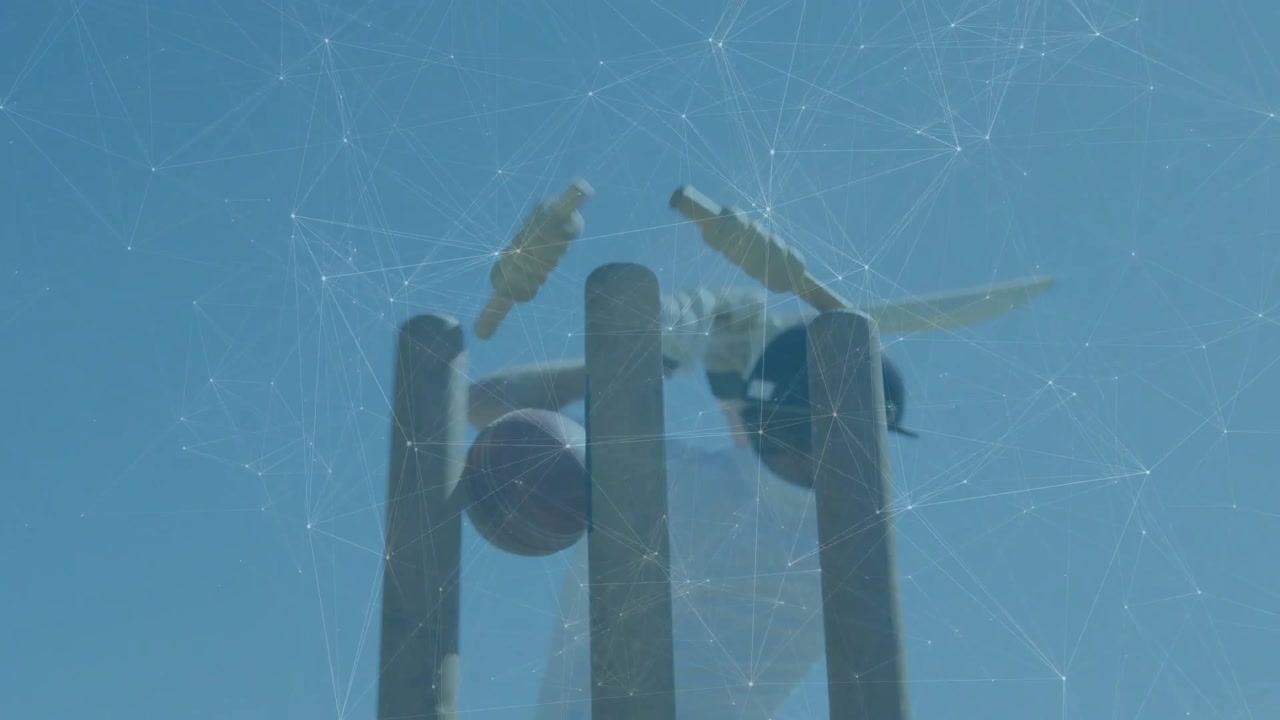 Male cricket batsman holding bat as red ball approaches, swinging and missing, dislodging bails