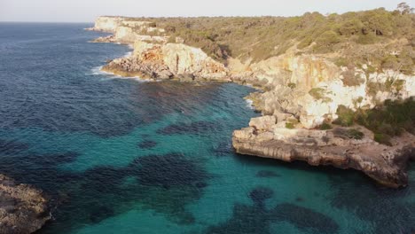 rugged arid cliffs and turquoise sea water of