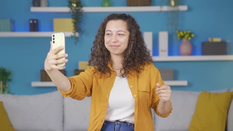 Dancing-young-woman-with-phone-in-hand.