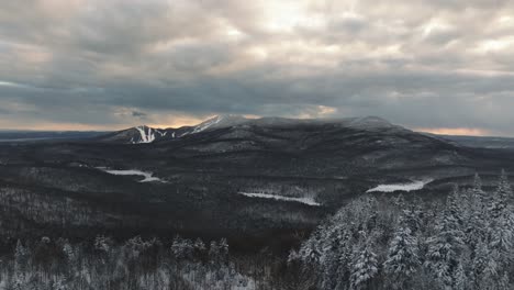 sunset over mountains and forests in winter