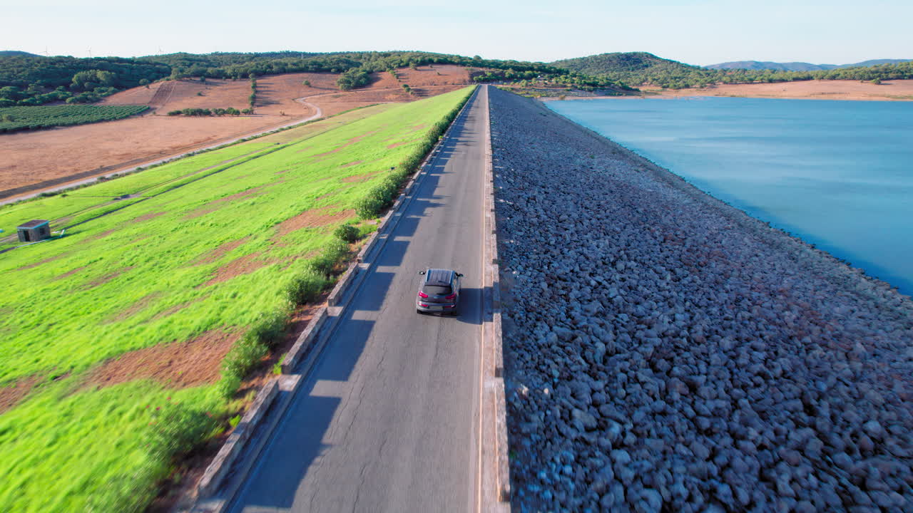 Car driving on a road along the Embalse de Barbate in Cádiz, Spain