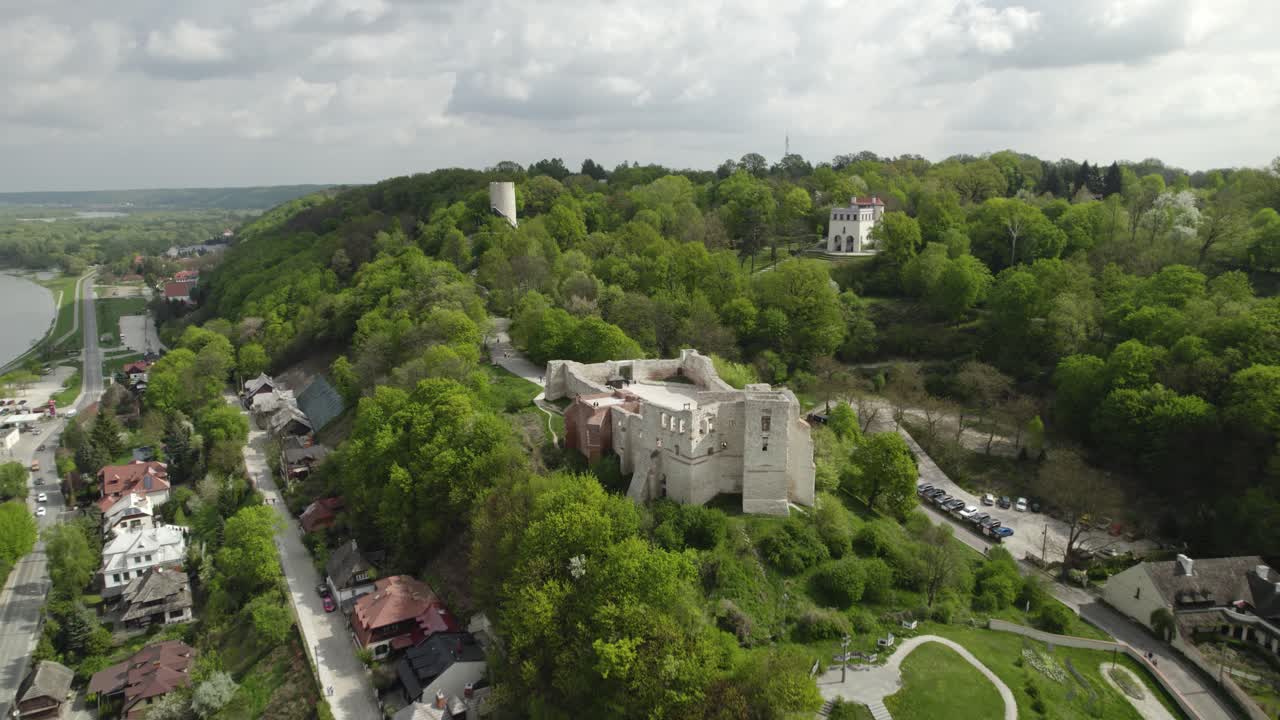 Fast aerial dolley view of the Dolny Castle and other historical buildings on the hill in Kazimierz