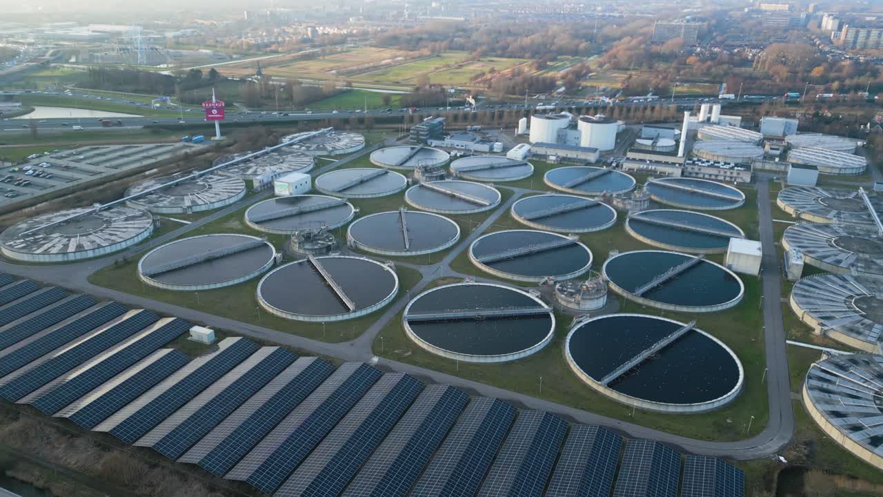 Drone shot of multiple circular clarifier tanks at a large wastewater treatment facility