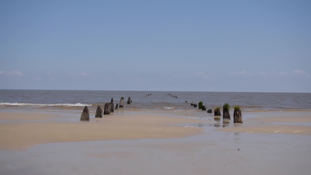 Young man rides bike on beach