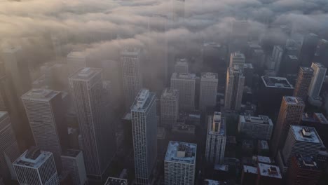 skyscrapers emerging from dense fog layer, revealing urban landscape with dramatic skyline silhouettes during early morning light, creating ethereal metropolitan atmosphere