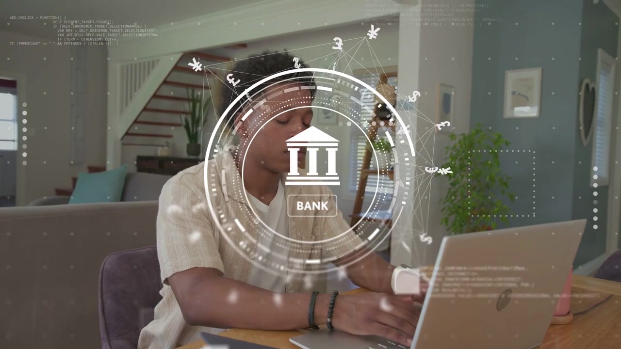 Man typing on laptop managing online banking via HUD with currency symbols, pausing then stretching