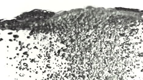 tiny bubbles moving to water surface in super slow motion