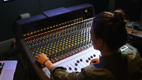 Male-audio-engineer-using-sound-mixer