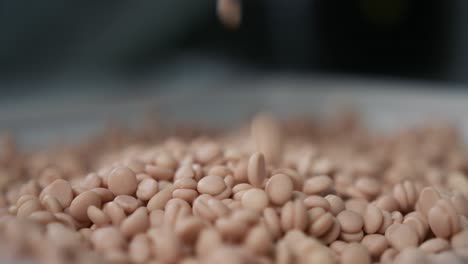 slow motion shot of granules for milling machine coolant falling down and creating a pile of granules