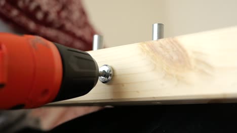 drilling a screw into wood