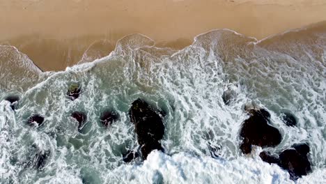 Top-shot-beautiful-waves-crashing-rocky-in-the-ocean-of-a-tropical-country