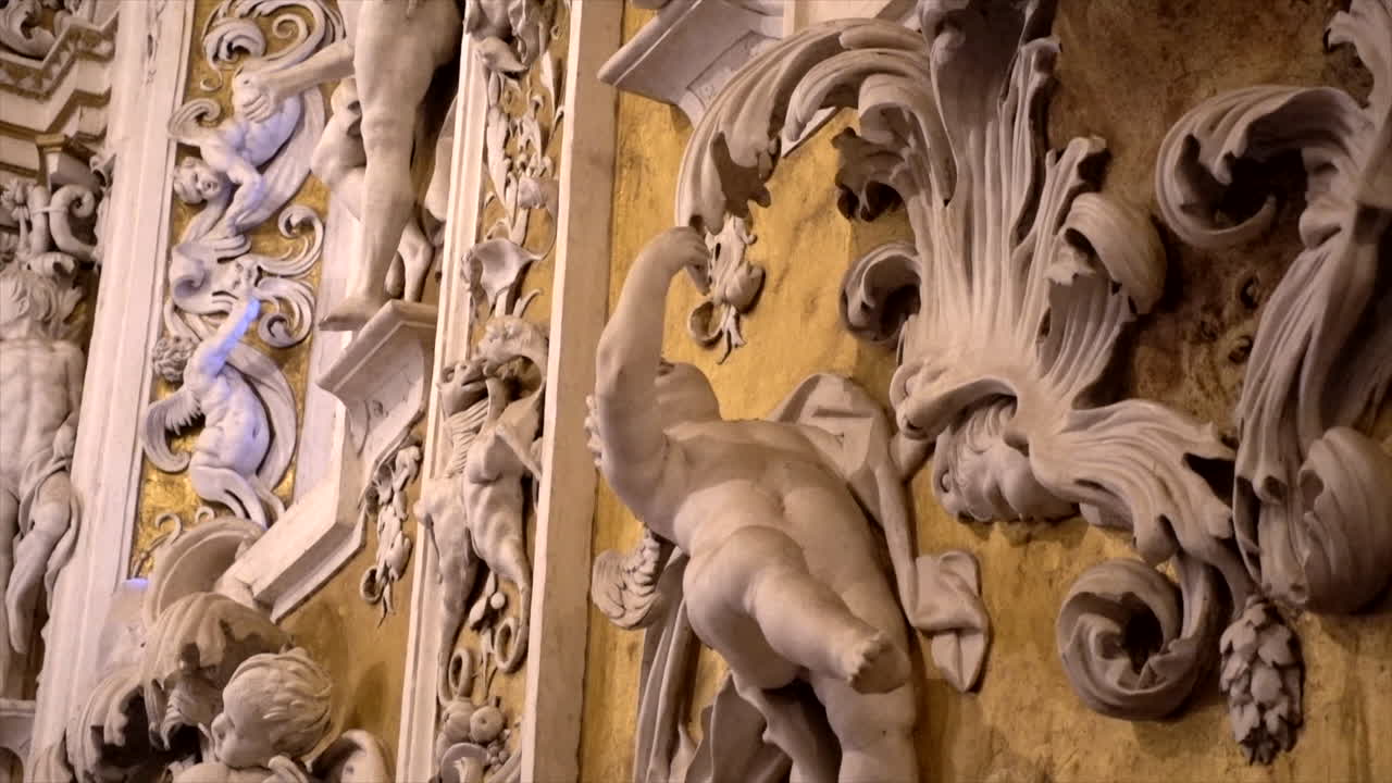 Stuccoes and statues inside the Serpotta Chapel of Castelbuono Castle, Sicily. Angels, devils, and fierce demonic faces decorate this masterpiece, showcasing Baroque artistry at its finest.