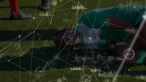 Animation-of-connected-dots,-graph-icons-over-injured-african-american-male-player-lying-on-ground