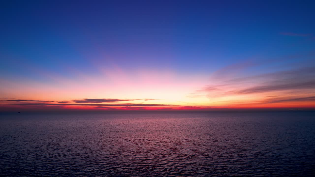 Drone Colorful Bright Pink, Yellow, and Orange Sunrise Over Calm Sea