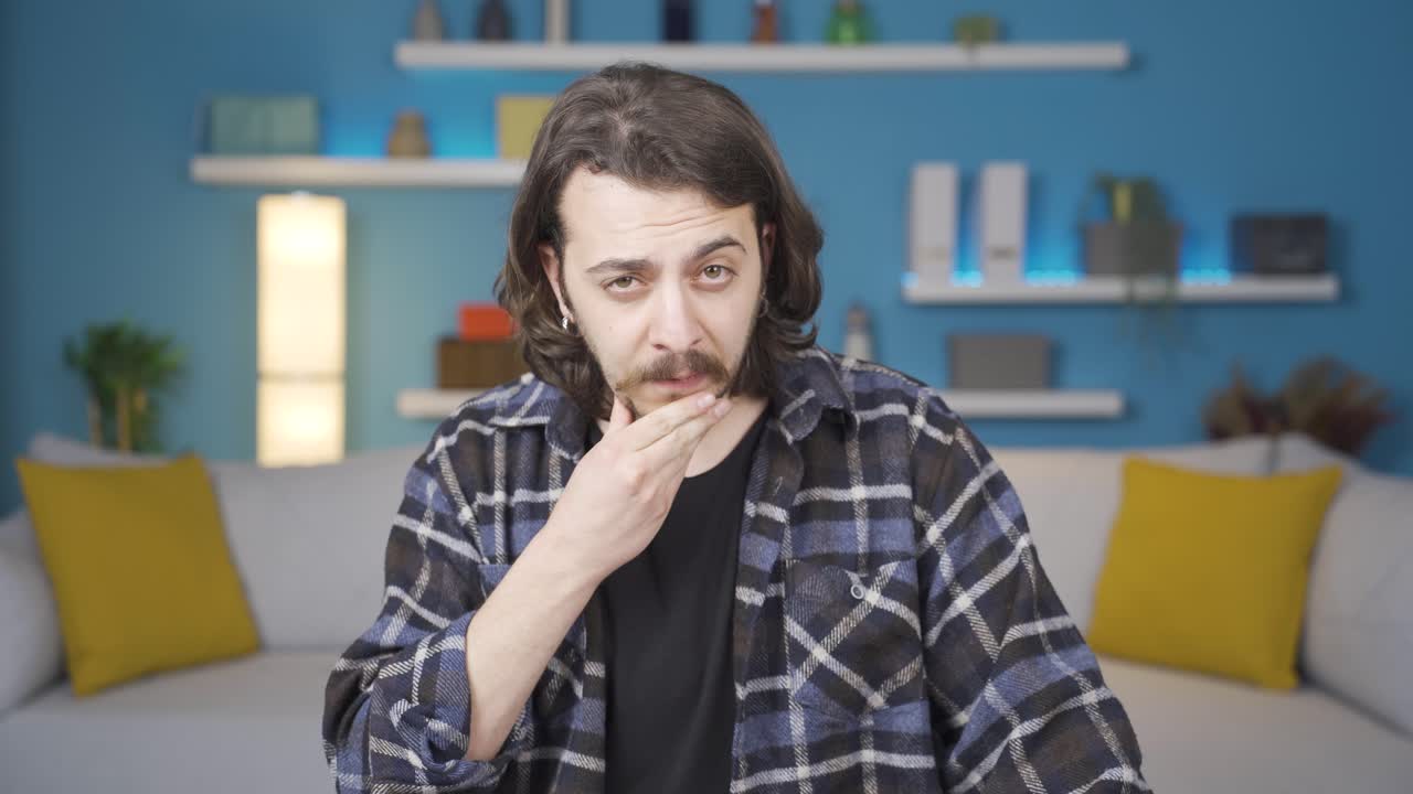 Trying to understand the situation, the man looks at the camera.