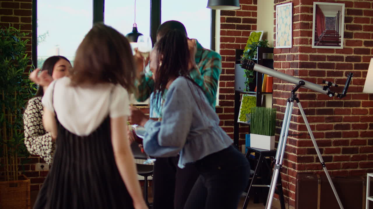Cheerful friends dancing at apartment party, having fun together, doing energetic dance moves