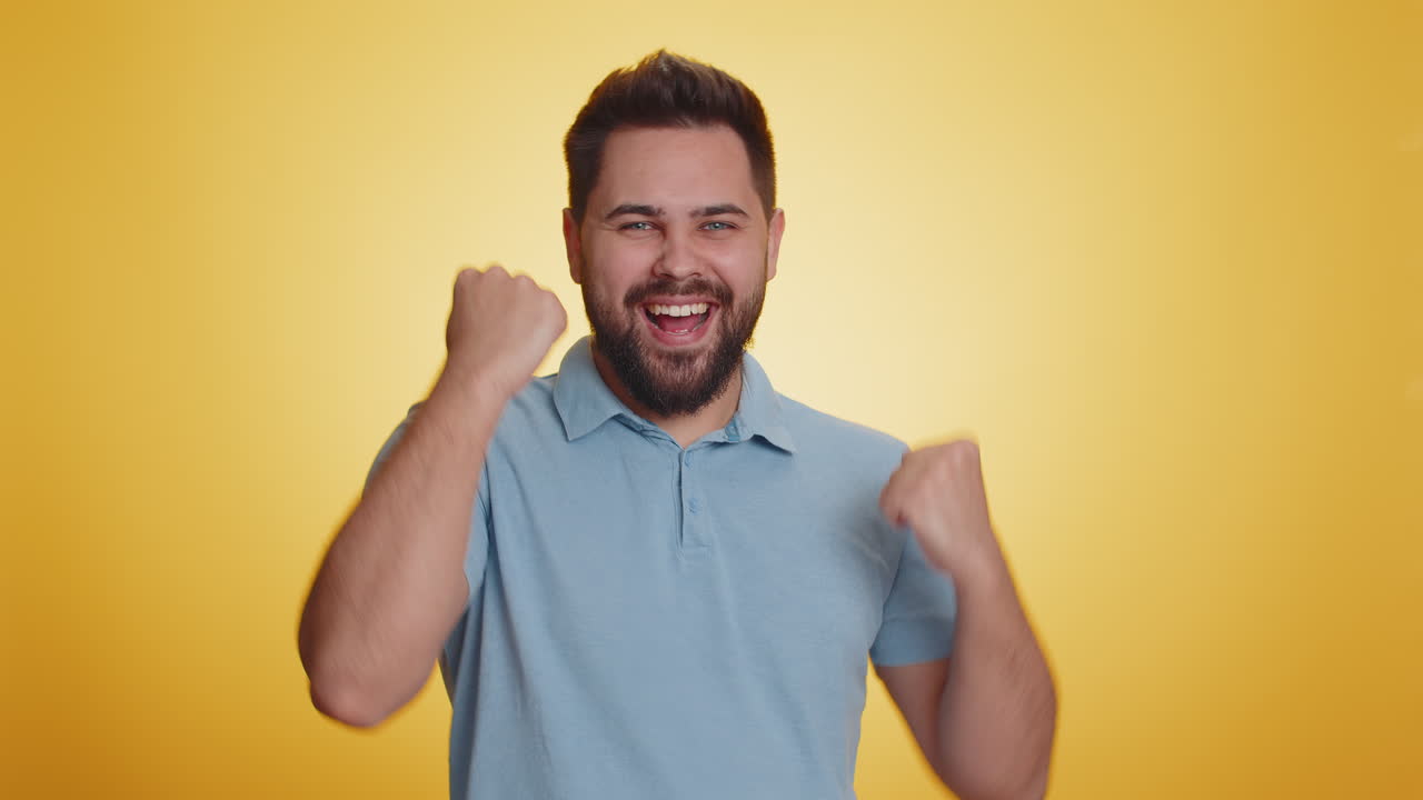 Happy young man celebrating success winning birthday lottery jackpot goal achievemen good news