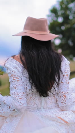 beautiful bride in the mountains. pretty young woman wearing long dress walking against mountains view