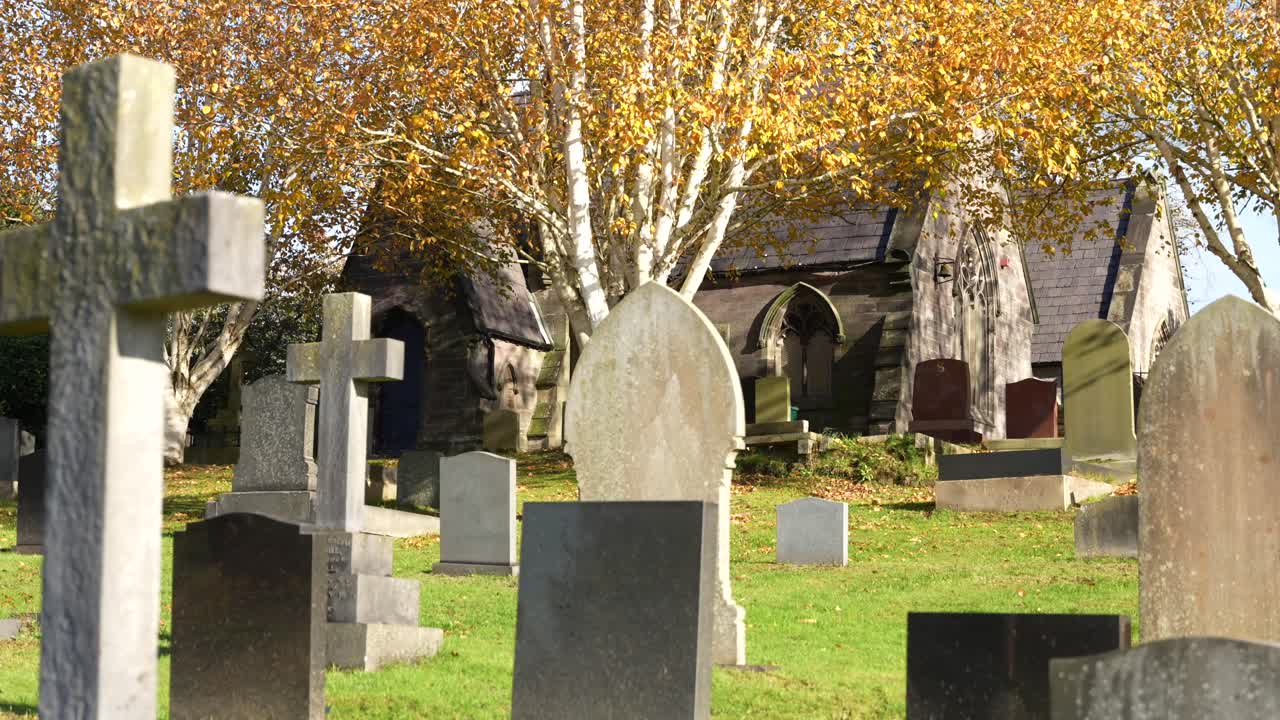 Cemetery with old headstones and church on a bright sunny autumn day