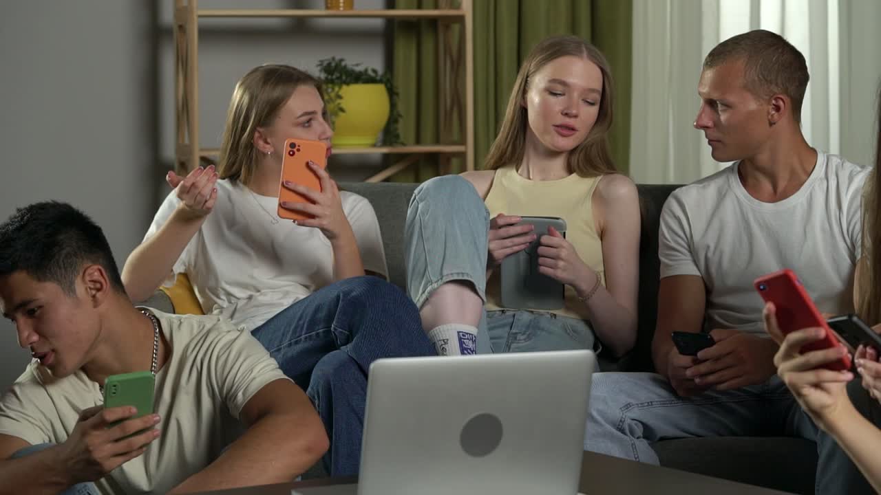 Friends using their smartphones and laptops