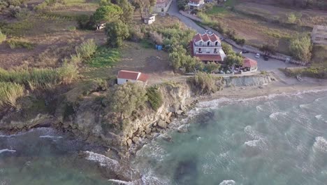 Inward-rotating-drone-footage-of-chapel-on-coastline-cliffs-on-the-island-of-Zakynthos-Greece