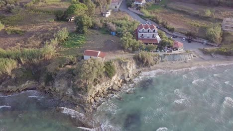 inward rotating drone footage of chapel on coastline cliffs on the island of zakynthos greece