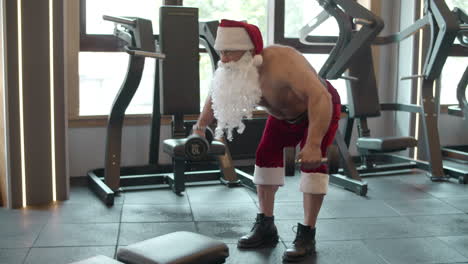 Strong-fitness-man-doing-dumbbell-swings-at-gym.-Strongman-workout-in-sport-club