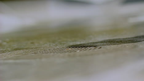 close-up of urban cleaning action with squeegee sliding over wet pavement