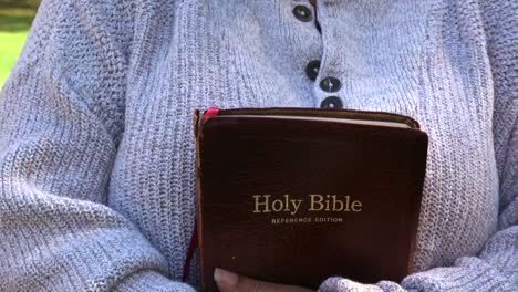 Extreme-closeup-of-African-American-female-Christian-holding-her-bible-Peace,-Hope-and-Serenity