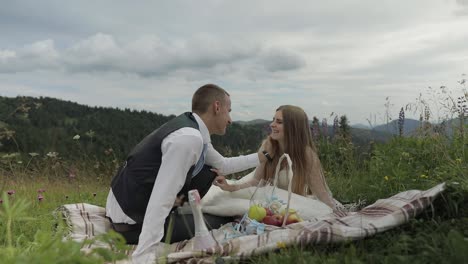 groom with bride having a picnic on a mountain hills. wedding couple. family