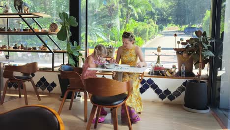 family crafting in a cafe with a garden view