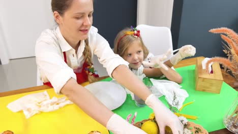 mom and daughter baking easter cupcakes together