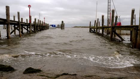 waves hitting the pier of a small harbor in rantum, sylt